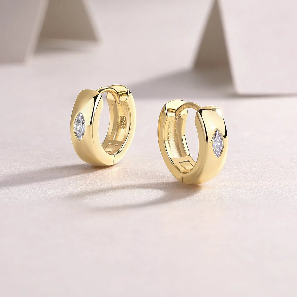Yellow gold vermeil huggie hoop earrings with bezel-set marquise moissanite, angled