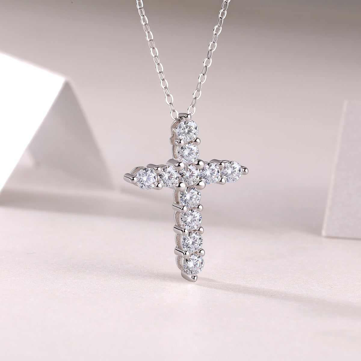 White metal cross pendant with multiple bezel-set round moissanite stones