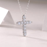 White metal cross pendant with multiple bezel-set round moissanite stones