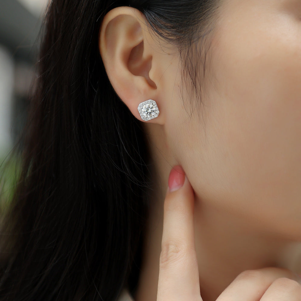 Moissanite stud earring in white gold vermeil with octagon halo, worn on ear