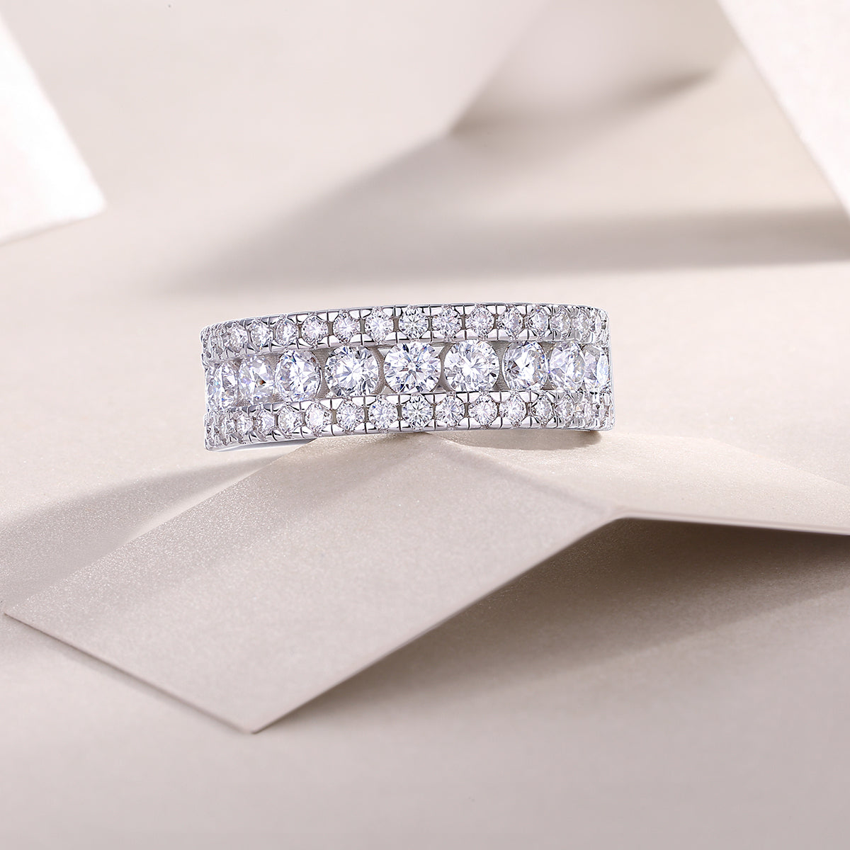 Triple row half eternity moissanite band, front view of stacked round stones