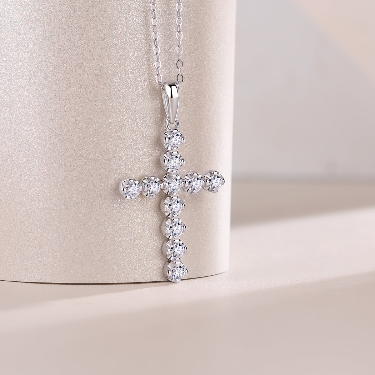 Cross pendant with round stones in a cluster, teardrop bail on link chain
