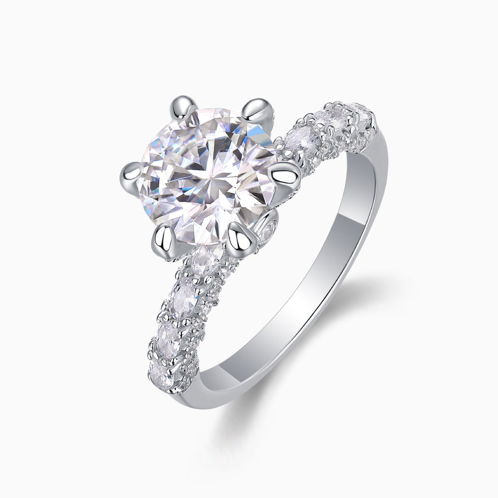 Side view of six-prong pavé moissanite engagement ring, round center stone and band
