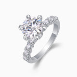 Side view of six-prong pavé moissanite engagement ring, round center stone and band