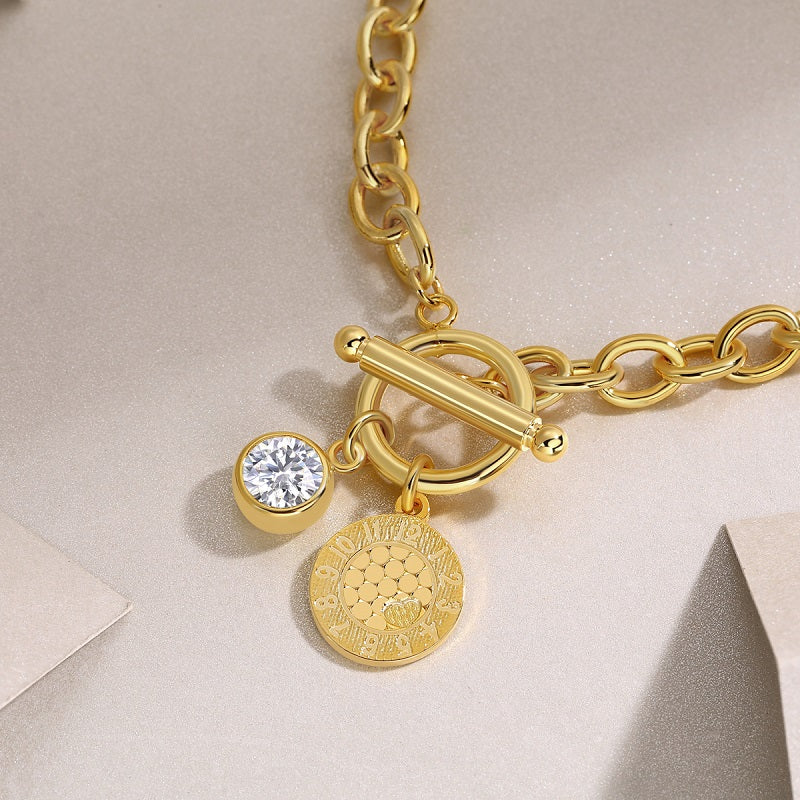 Toggle clasp close-up on yellow gold vermeil bracelet with coin and round stone
