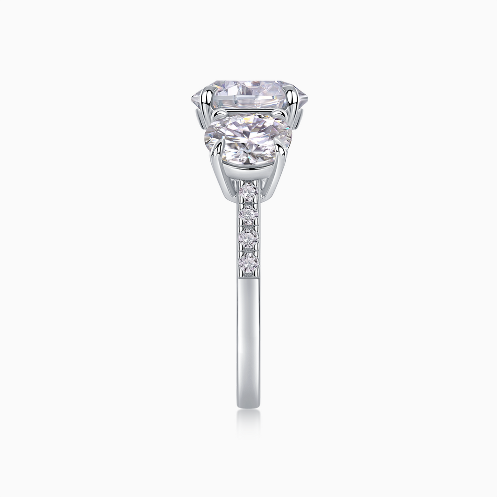 Three-round moissanite engagement ring with prongs and pavé-style band detail