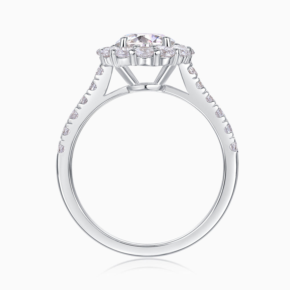 Top view of halo moissanite engagement ring, prong-set center stone, white gold vermeil