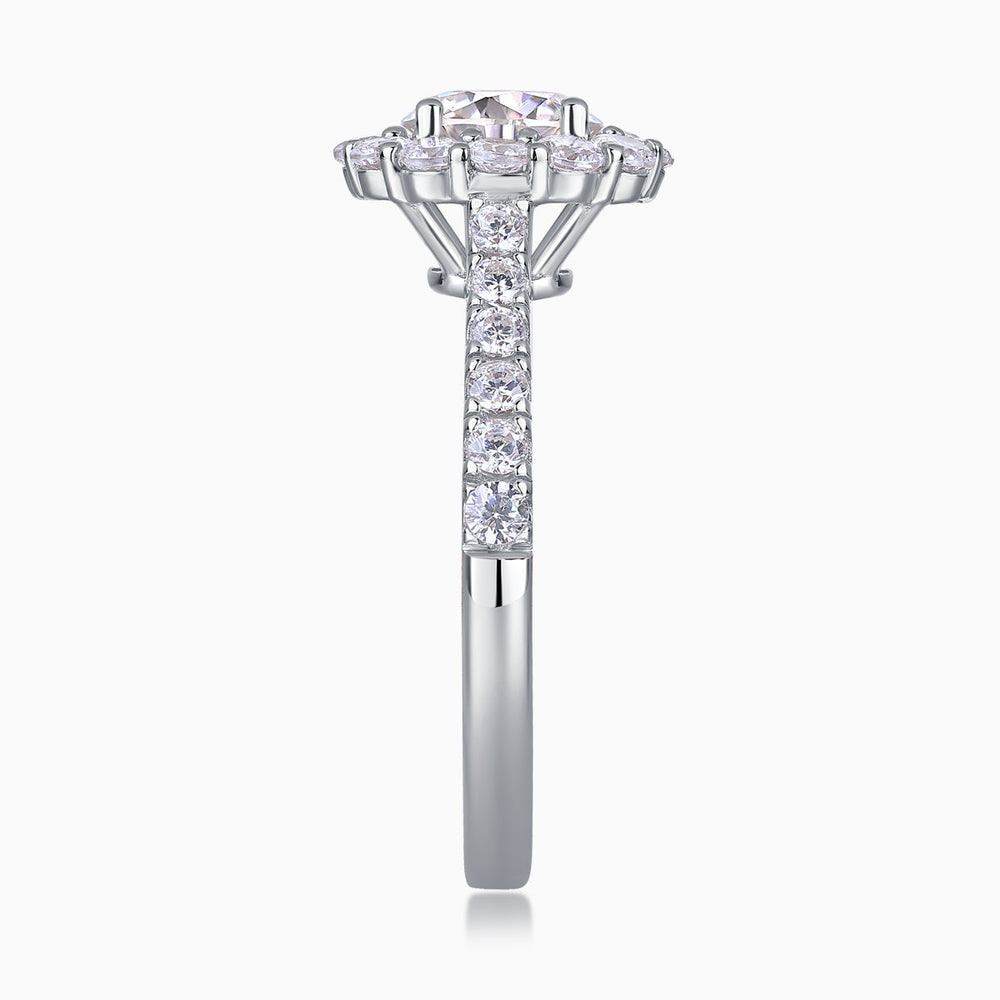 Side view of halo moissanite engagement ring with prong-set center stone, white gold vermeil