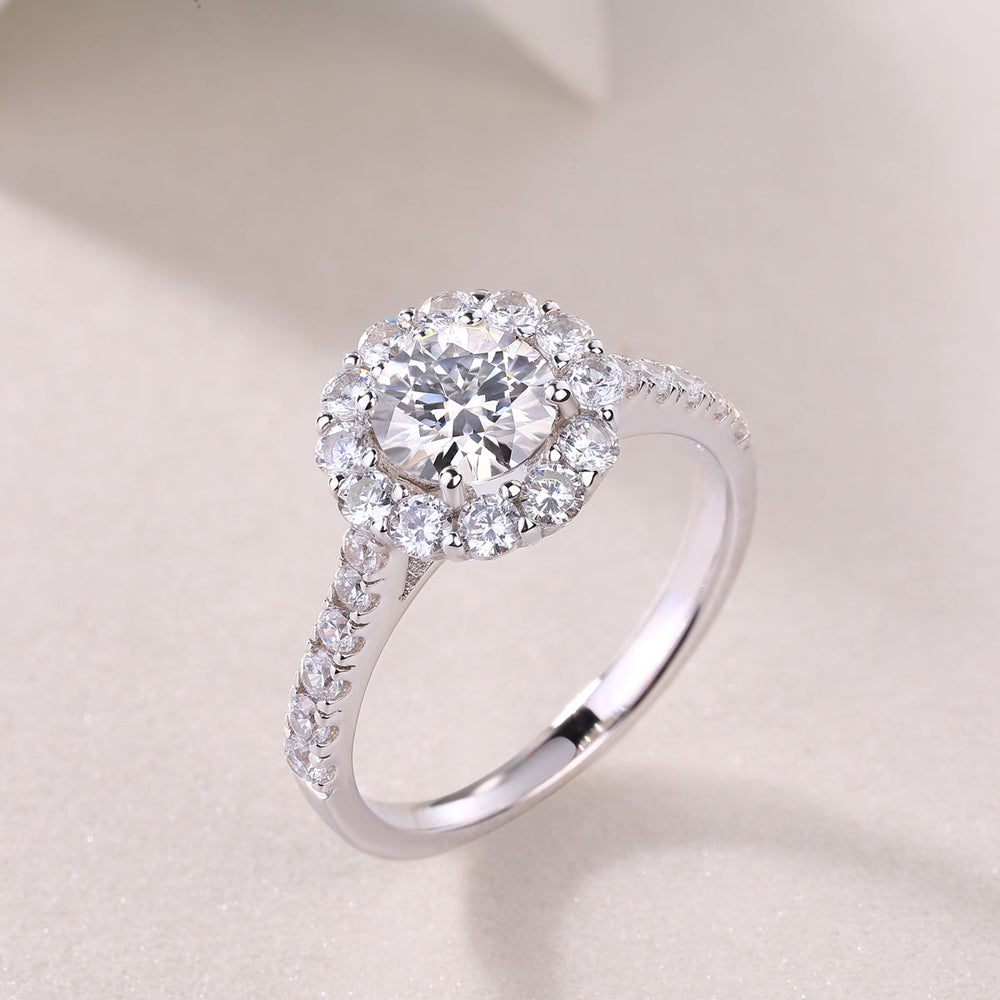 Halo moissanite engagement ring angled view, pavé band and round center stone, white gold vermeil