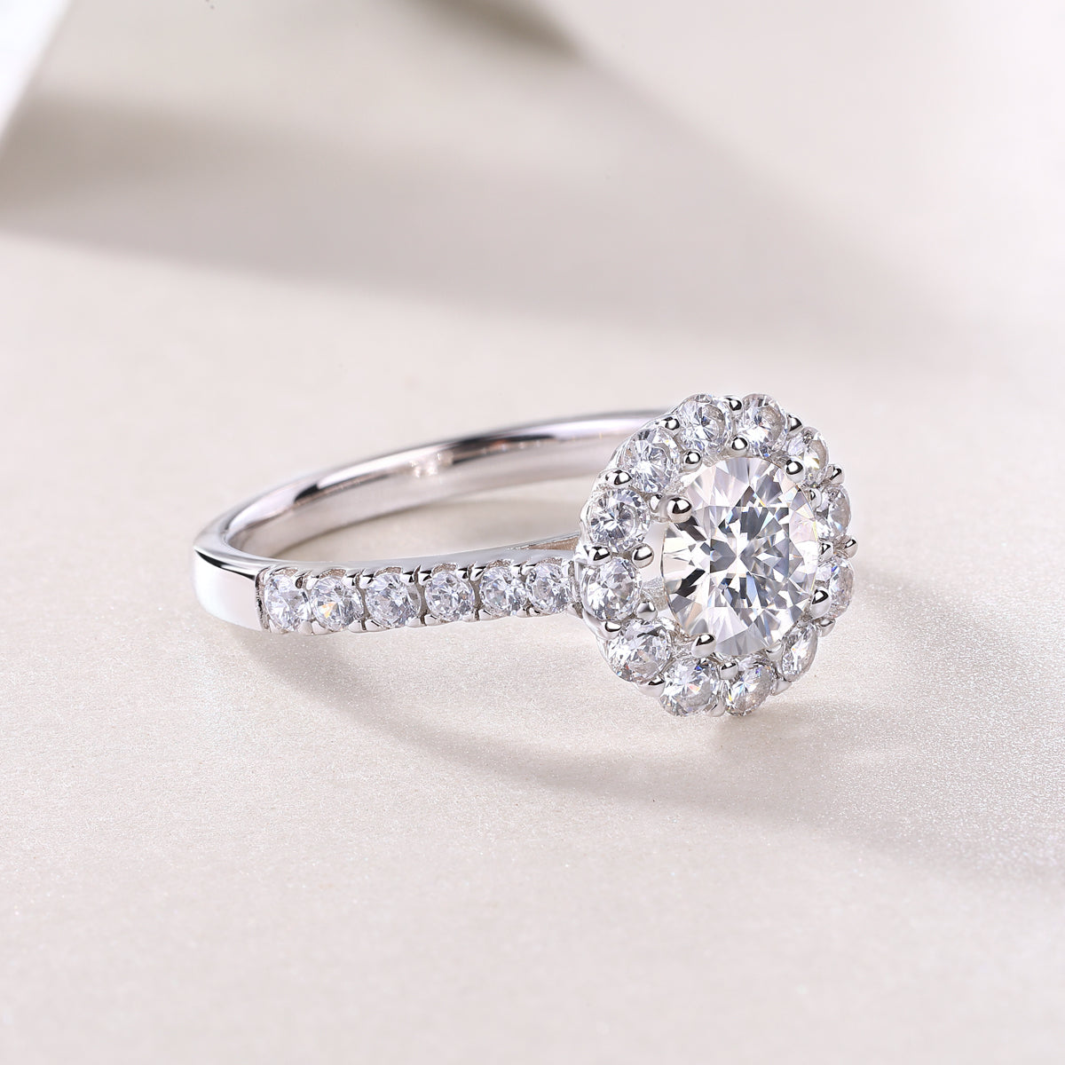 Halo moissanite ring with pavé band and round center stone, white gold vermeil