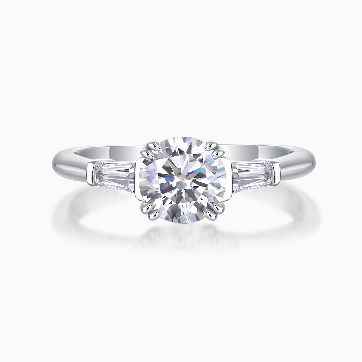 White metal three-stone ring with round center moissanite and baguette side stones
