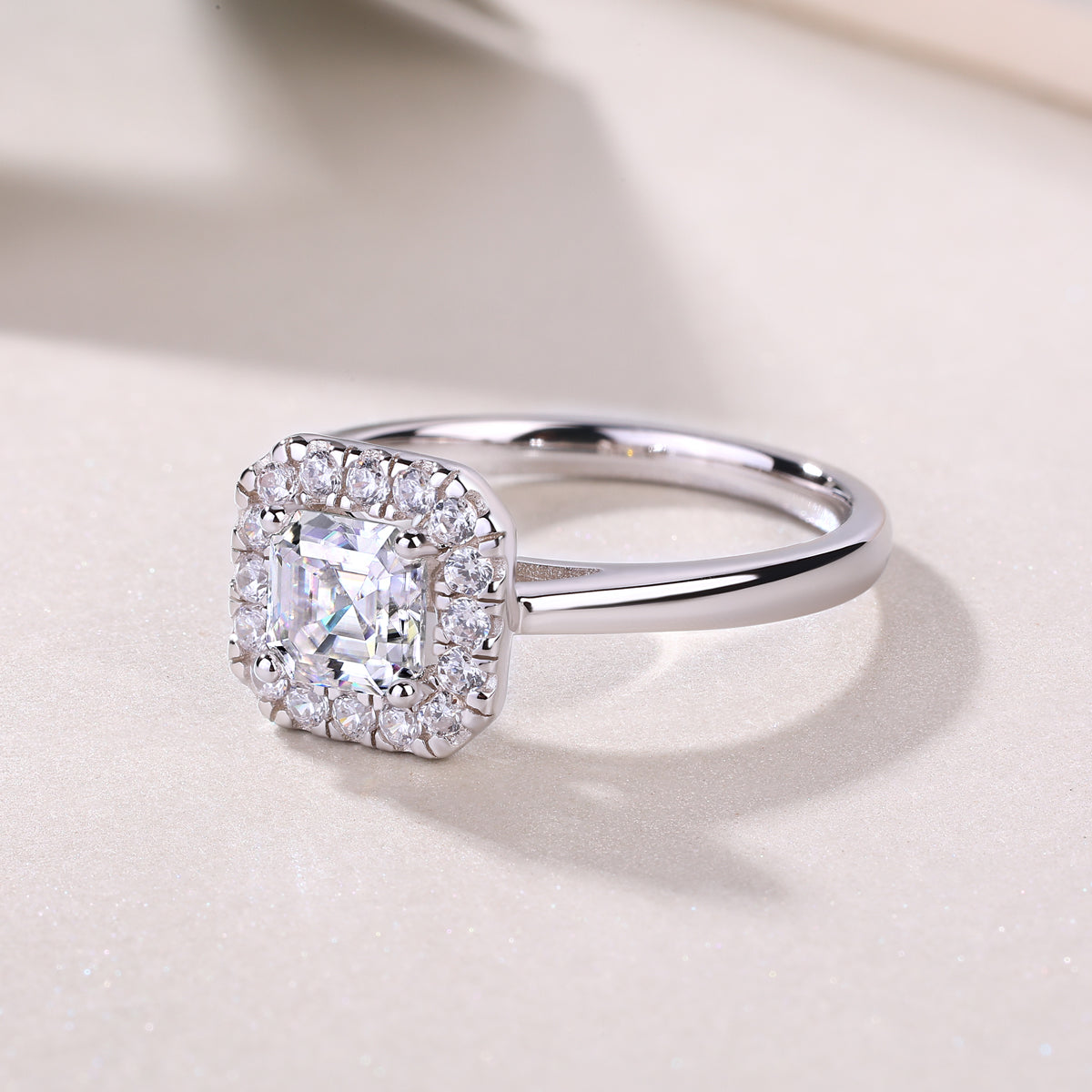 Asscher-cut solitaire moissanite ring, side angle showing halo and prong setting