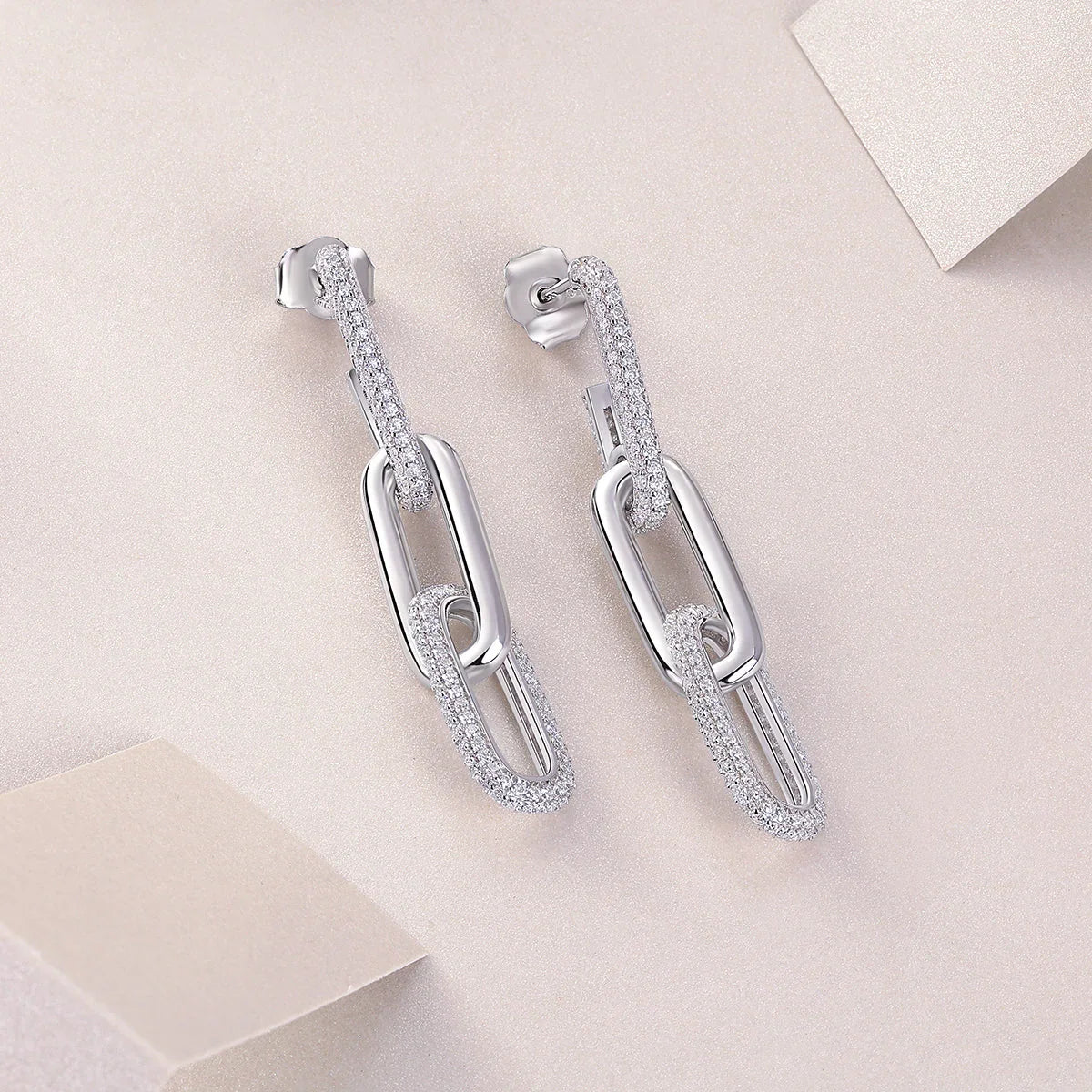 Pavé bar paperclip link drop earrings, angled view showing oval hoops and stud back