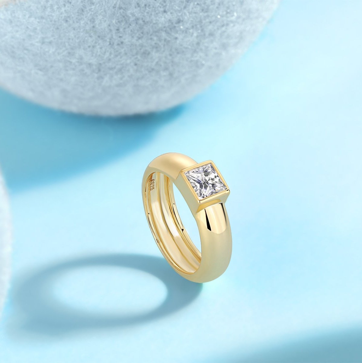 Side view of yellow gold vermeil solitaire ring with square moissanite centerpiece