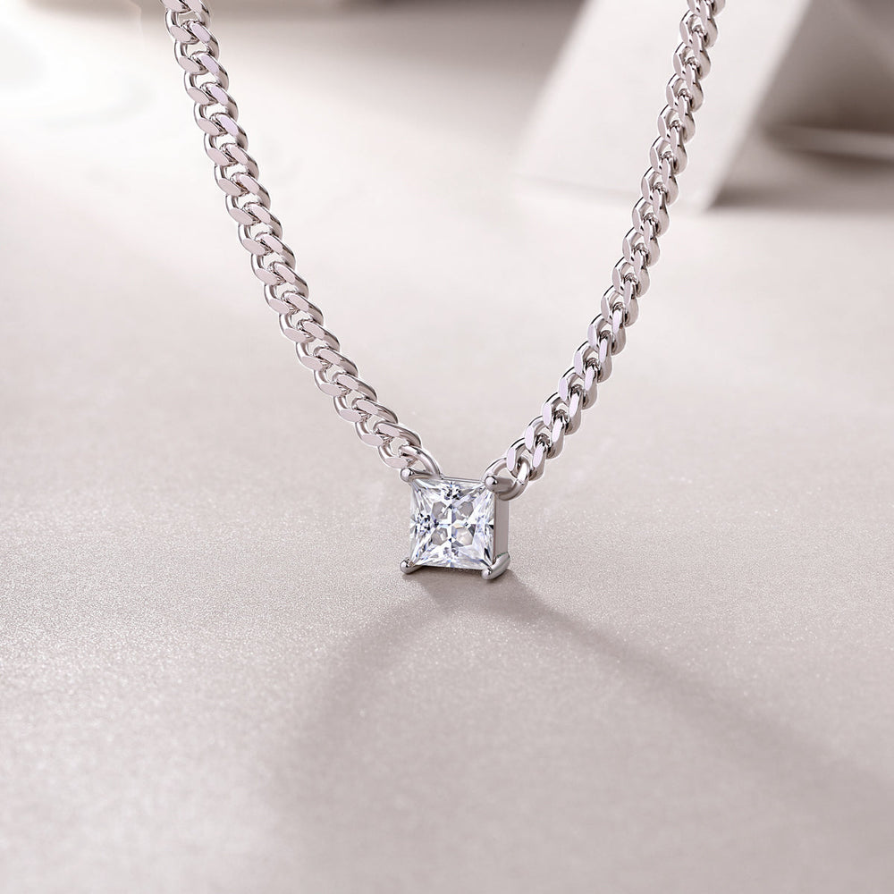 Square moissanite pendant centered on Cuban link chain with prong-set corners