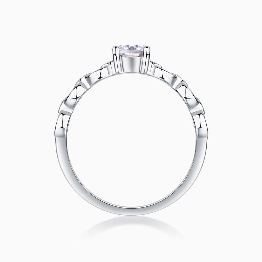 Oval moissanite ring top view with prong-set center stone and chain-link band
