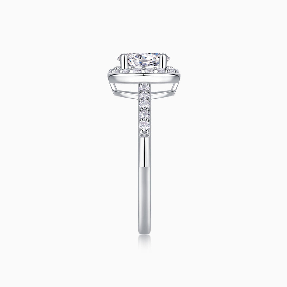 Side profile of oval Moissanite engagement ring, pavé halo, white gold vermeil
