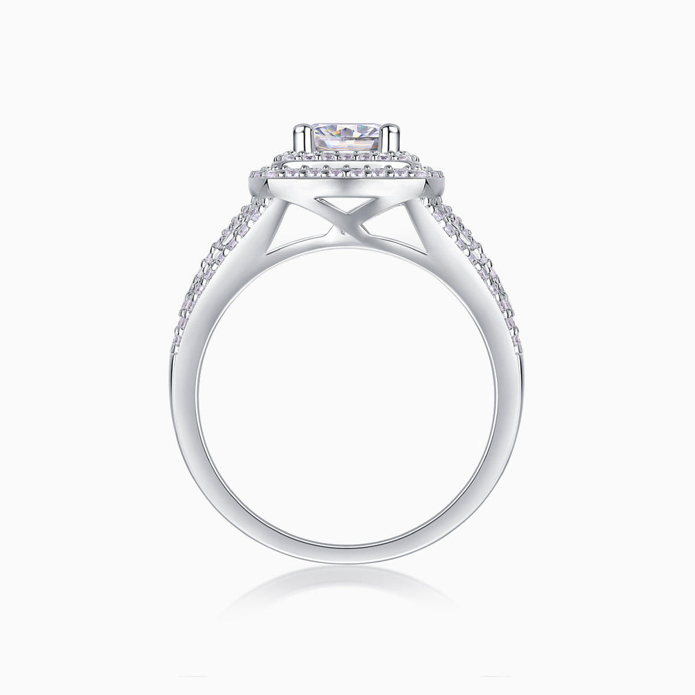 White gold-plated ring with cushion center and halo prongs, side view