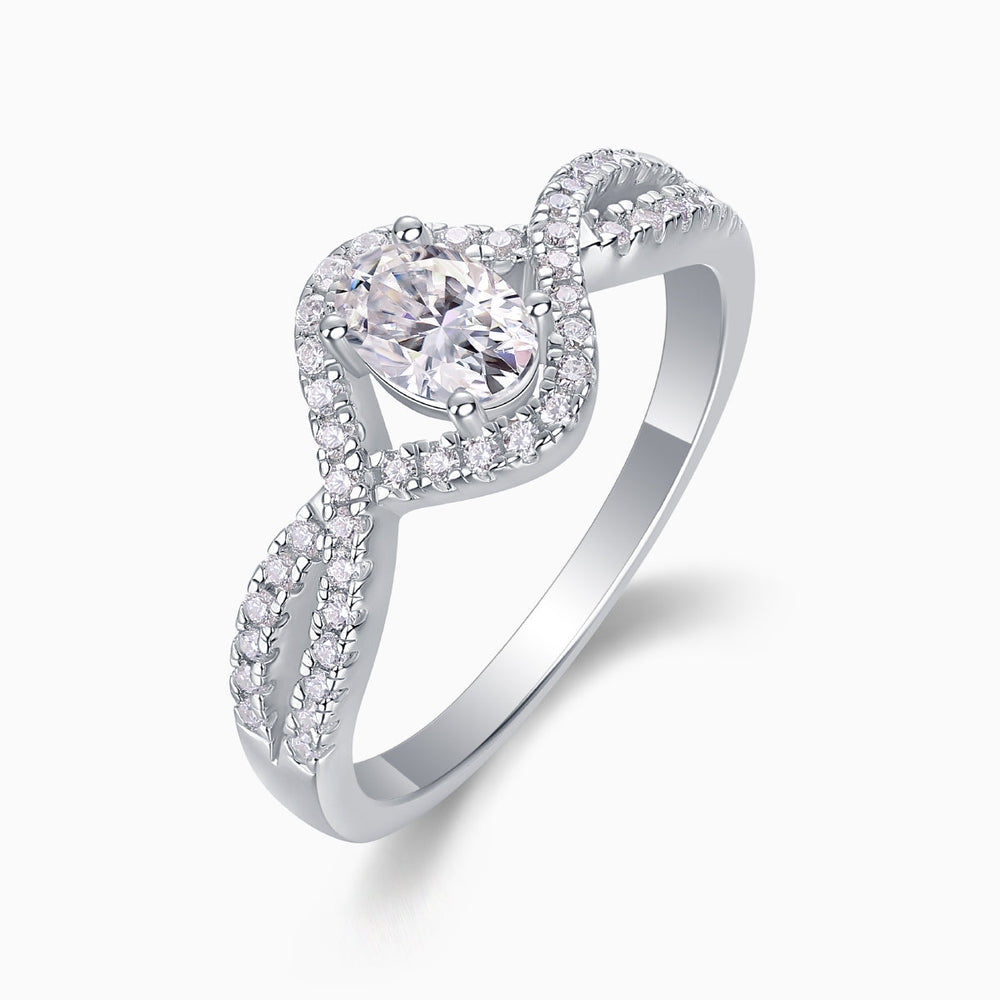 Oval moissanite center with pavé halo and twisted band detail, white gold vermeil