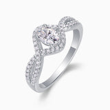 Oval moissanite center with pavé halo and twisted band detail, white gold vermeil