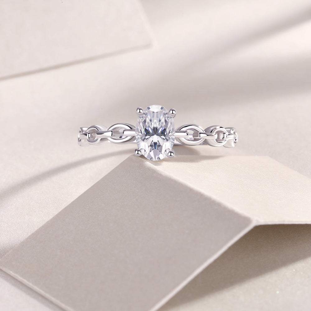 Oval moissanite chain link band ring with prong-set oval center stone, white gold