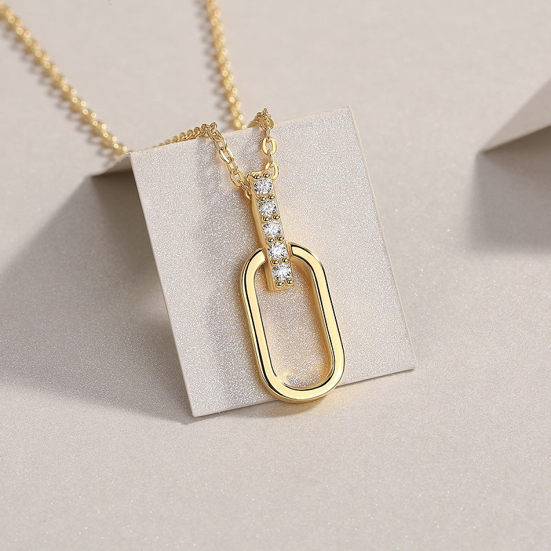 Close-up oval link pendant with pavé moissanite bar, yellow gold vermeil