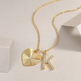 Close-up heart pendant with jeweled K initial on yellow-gold vermeil chain