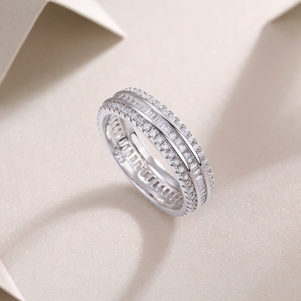 Three-row eternity ring with pavé outer rows and channel-set center stones