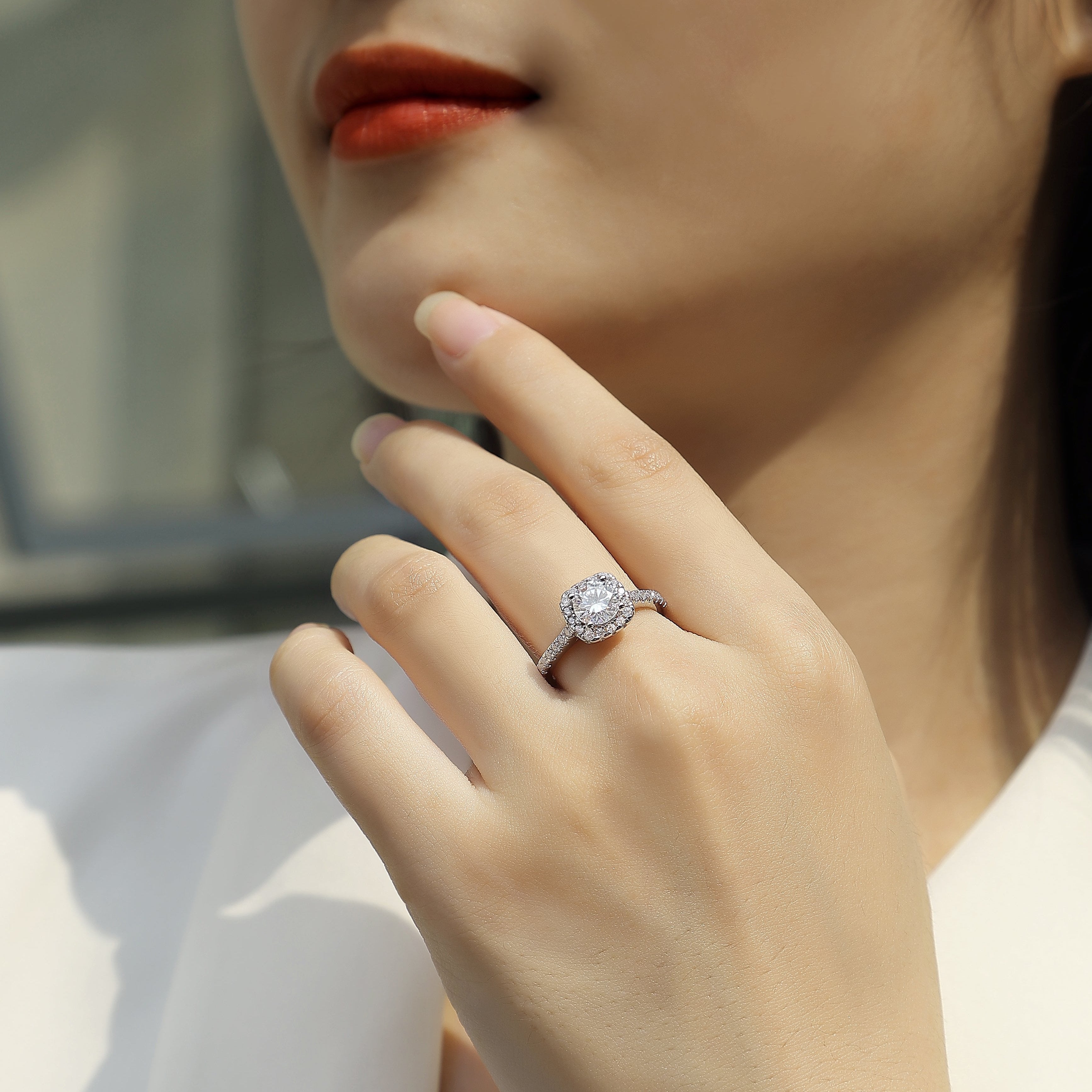 Round halo pavé moissanite ring on hand, clear center stone, slim pavé band