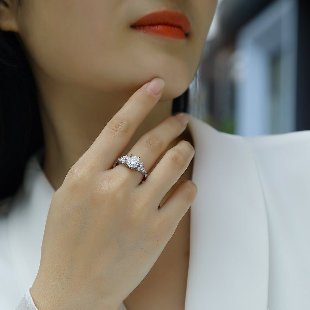 Moissanite pavé ring on hand, round center stone with pavé side accents, white gold