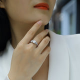 Moissanite pavé ring on hand, round center stone with pavé side accents, white gold