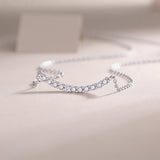 Curved bar moissanite smile necklace side view with pavé-like round stone settings