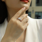 Round halo cluster ring on hand, pavé side stones in white gold vermeil