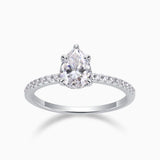 Pear cut pavé moissanite engagement ring, prong-set pear center, white metal band