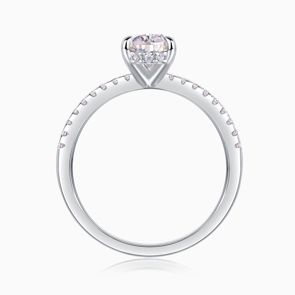 White metal pavé band engagement ring with prong-set pear center