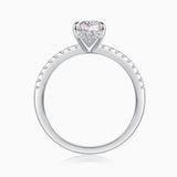 White metal pavé band engagement ring with prong-set pear center