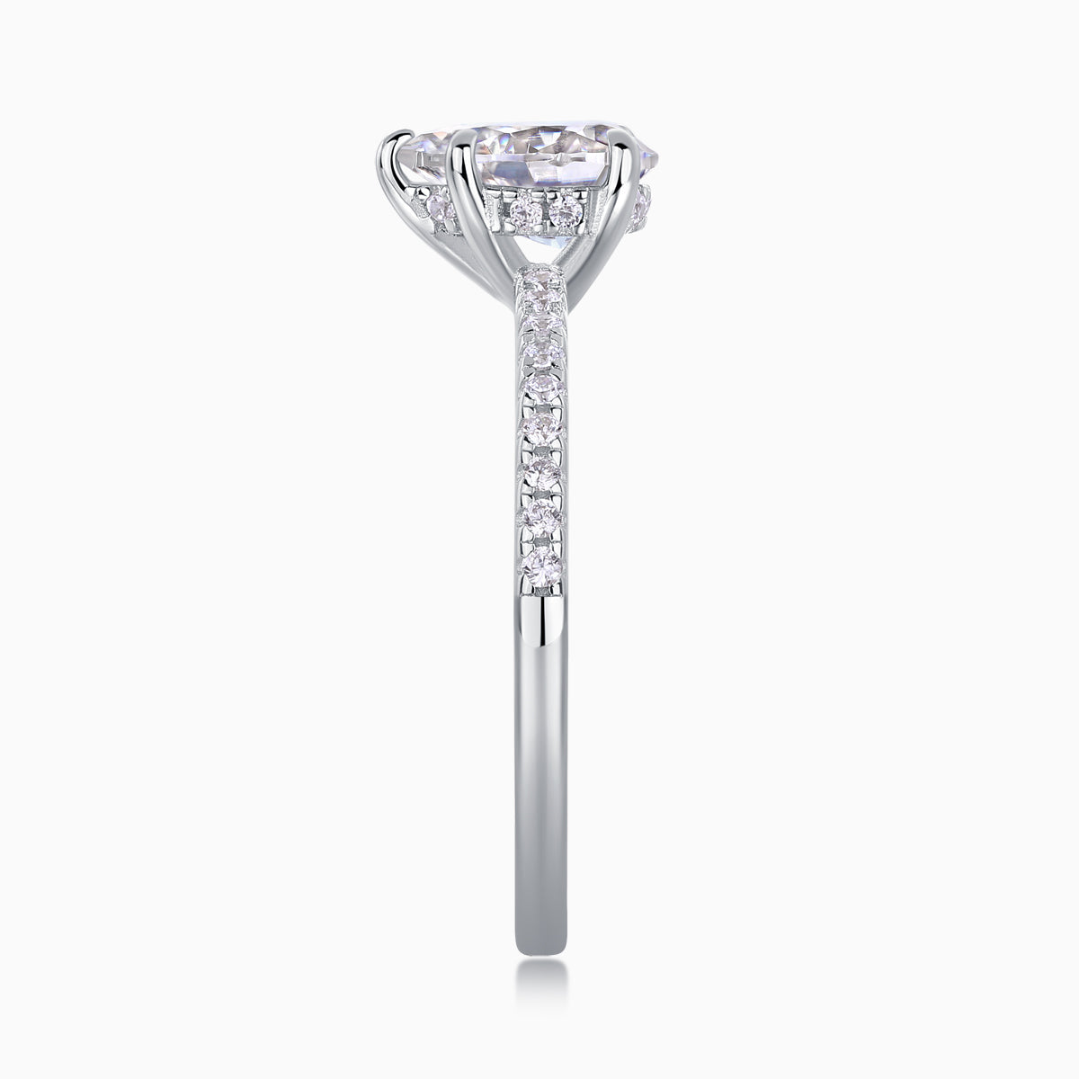 Prong-set pear cut moissanite engagement ring with pavé detail shank
