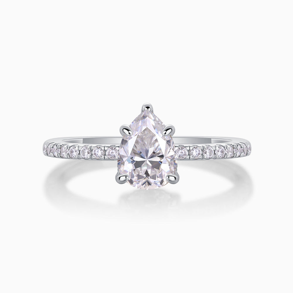 Pear cut moissanite engagement ring with pavé band and four-prong pear setting