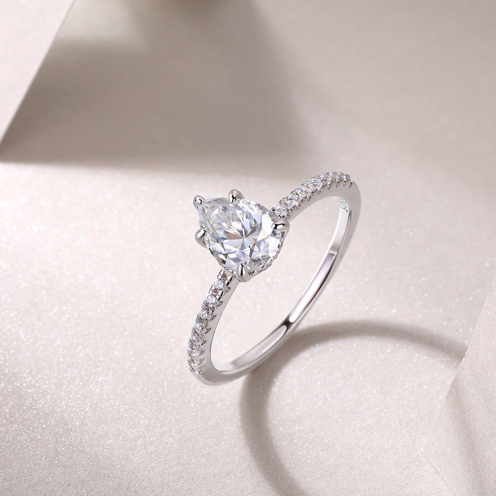 Pear cut pavé moissanite ring, prong-set pear center with curved pavé shank