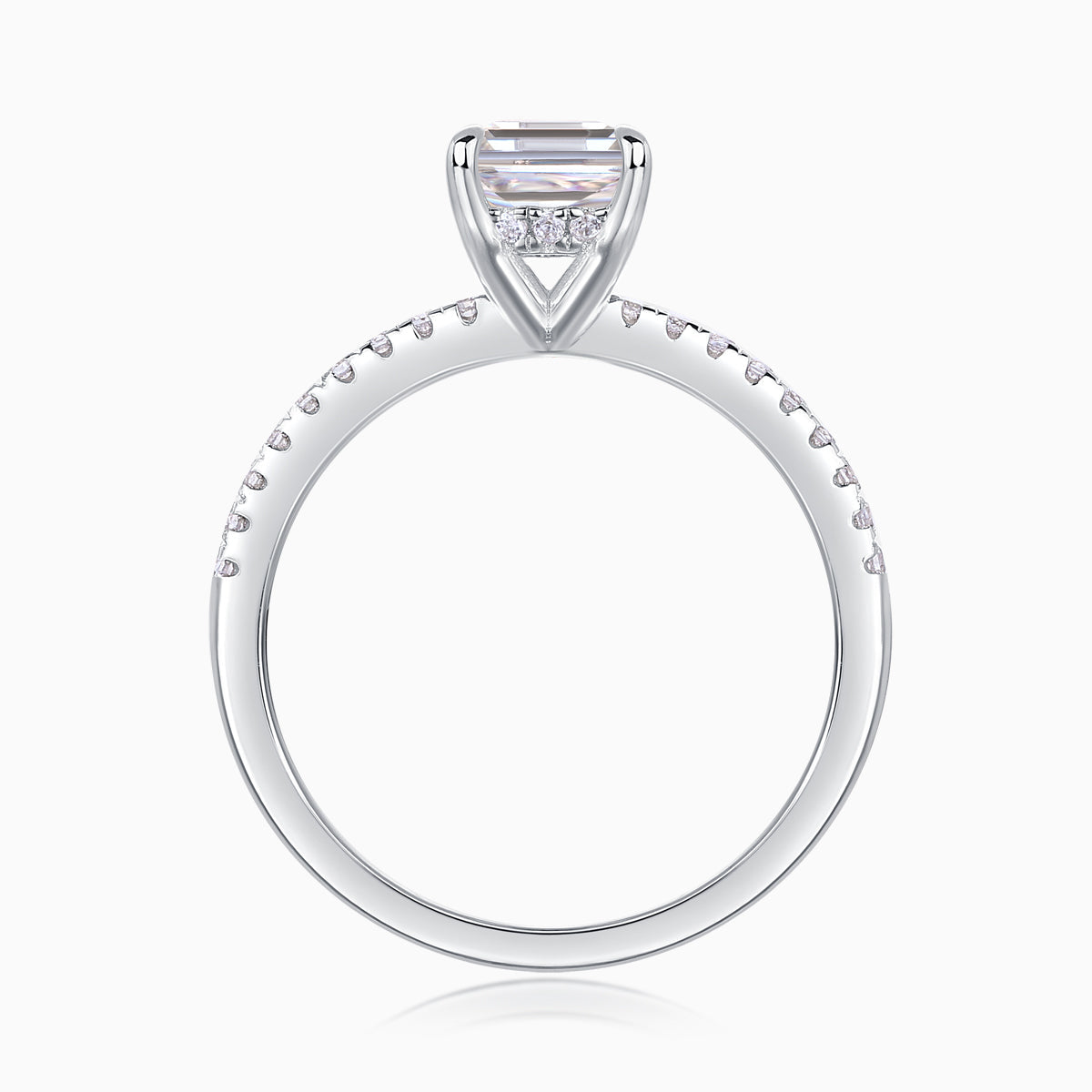 Emerald-cut center stone in four-prong setting, pavé band, white gold vermeil