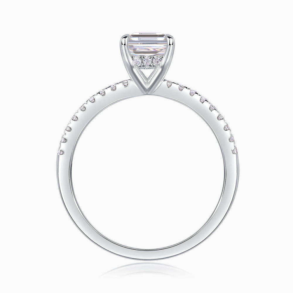 Emerald-cut center stone in four-prong setting, pavé band, white gold vermeil