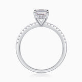 Emerald-cut center stone in four-prong setting, pavé band, white gold vermeil