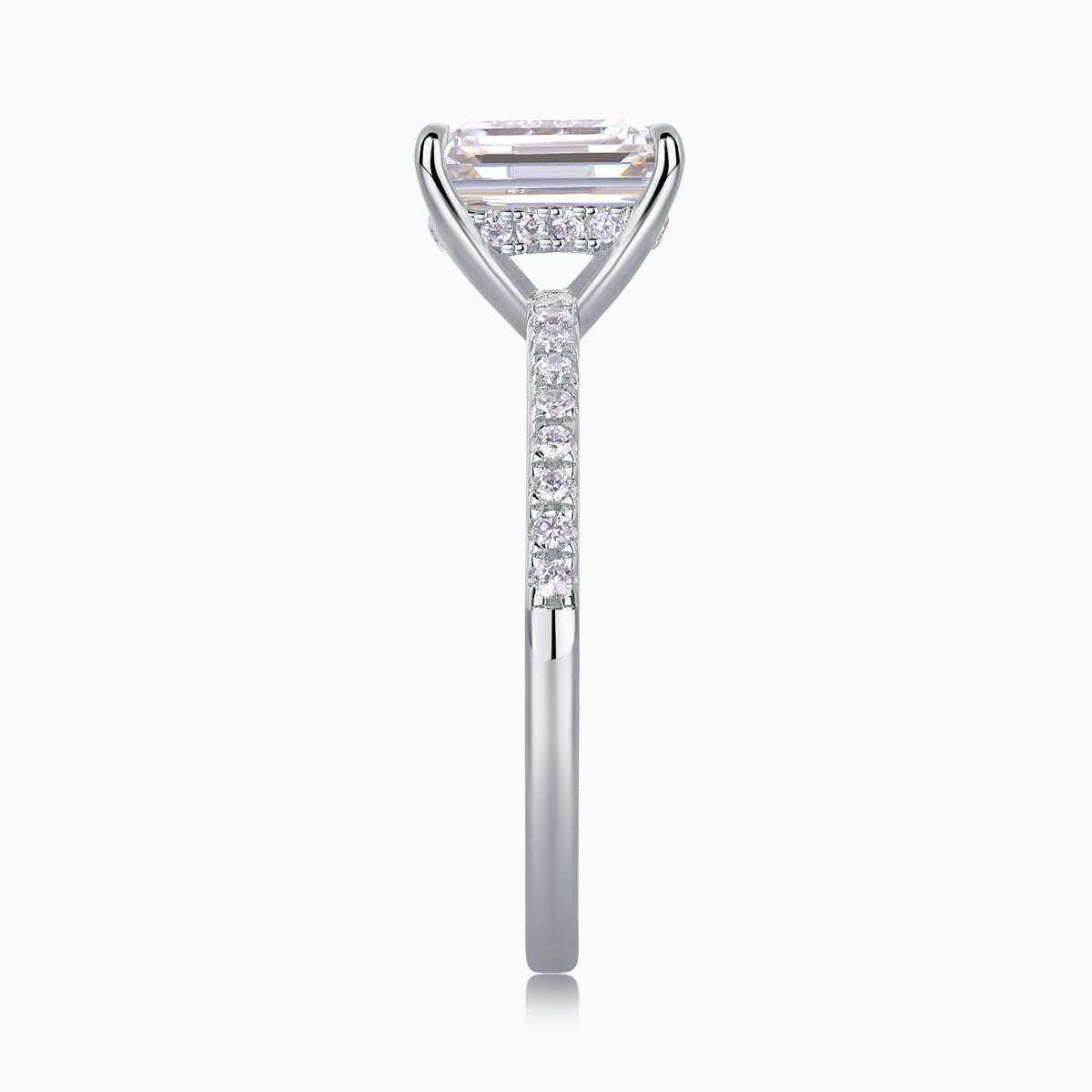 White gold vermeil ring showing emerald-cut stone with pavé shoulders, moissanite