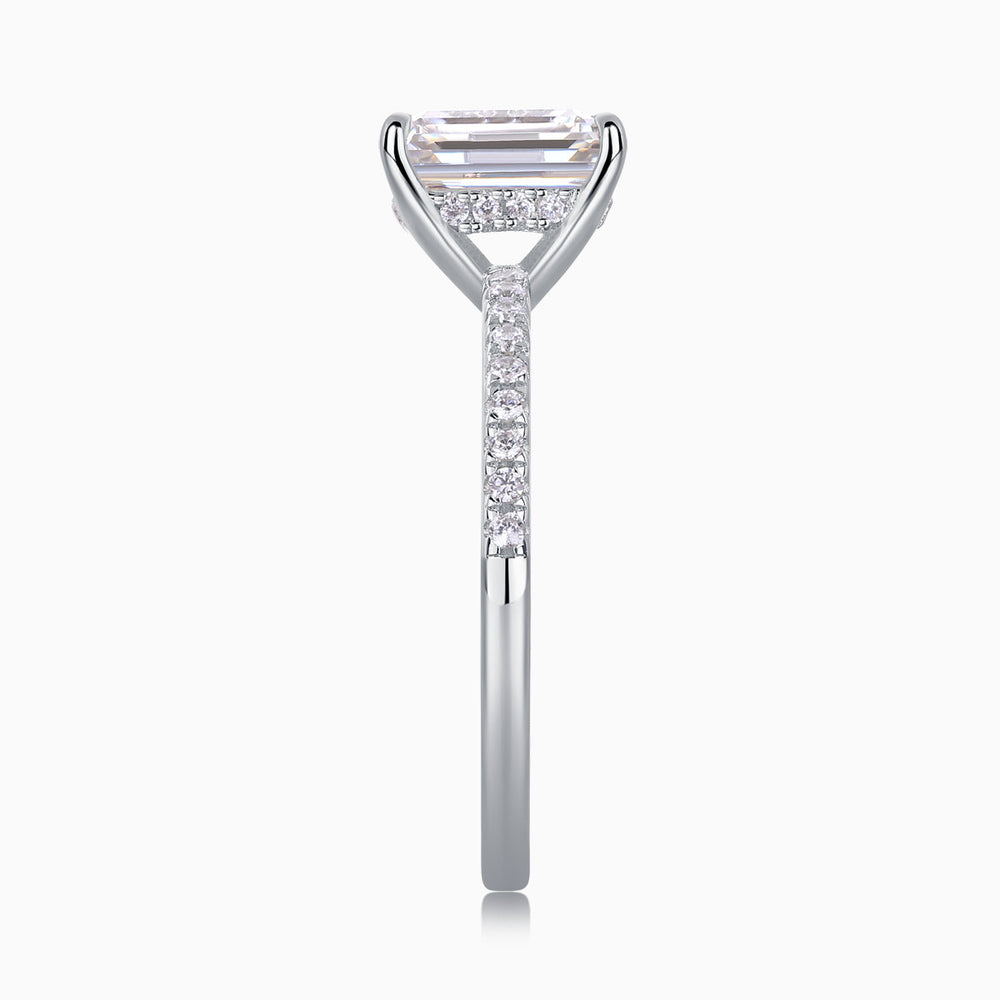 White gold vermeil ring showing emerald-cut stone with pavé shoulders, moissanite