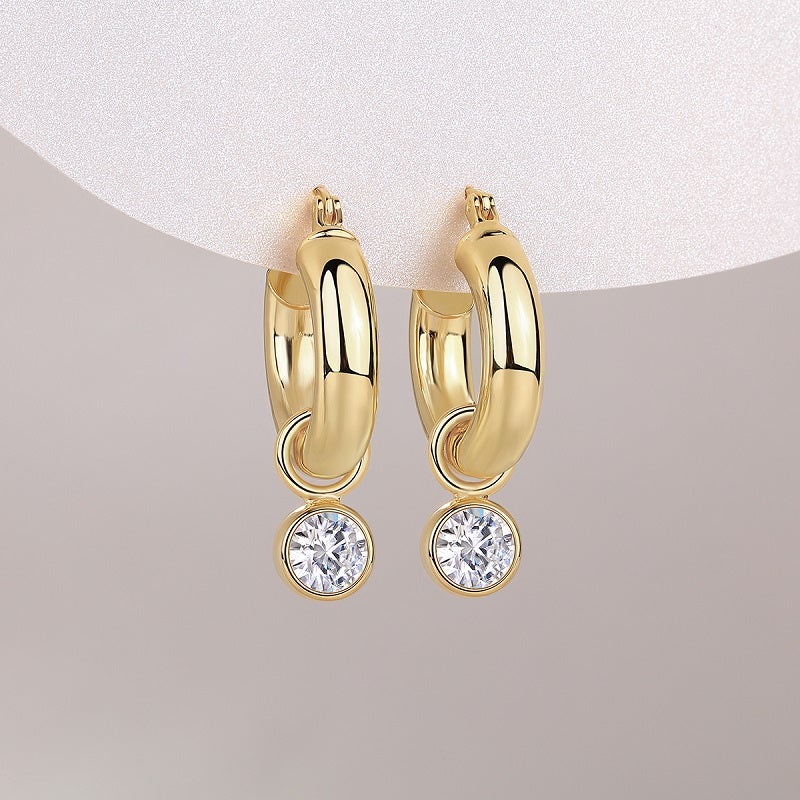 Round moissanite drop hangs from chunky gold hoops, yellow gold vermeil