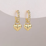 Pair of yellow gold vermeil heart charm earrings on beaded huggie bands