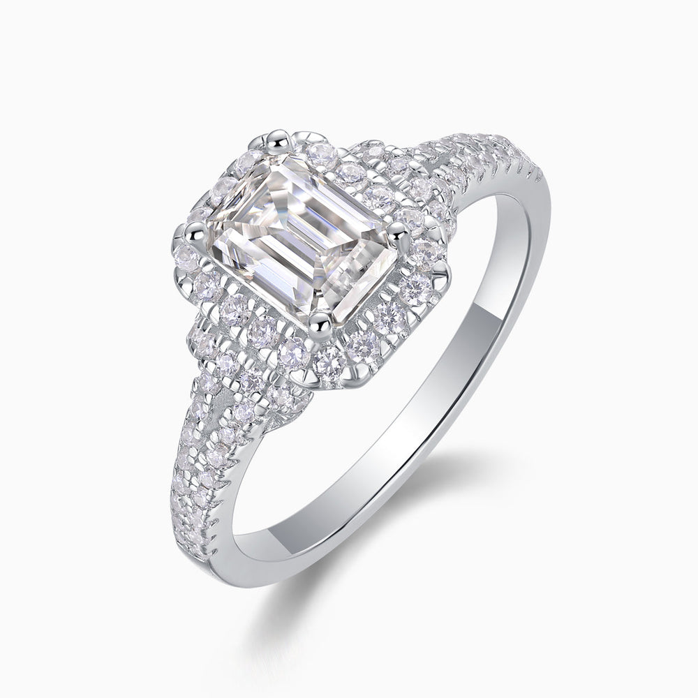 Angled view of emerald-cut halo moissanite ring with double pavé split shank