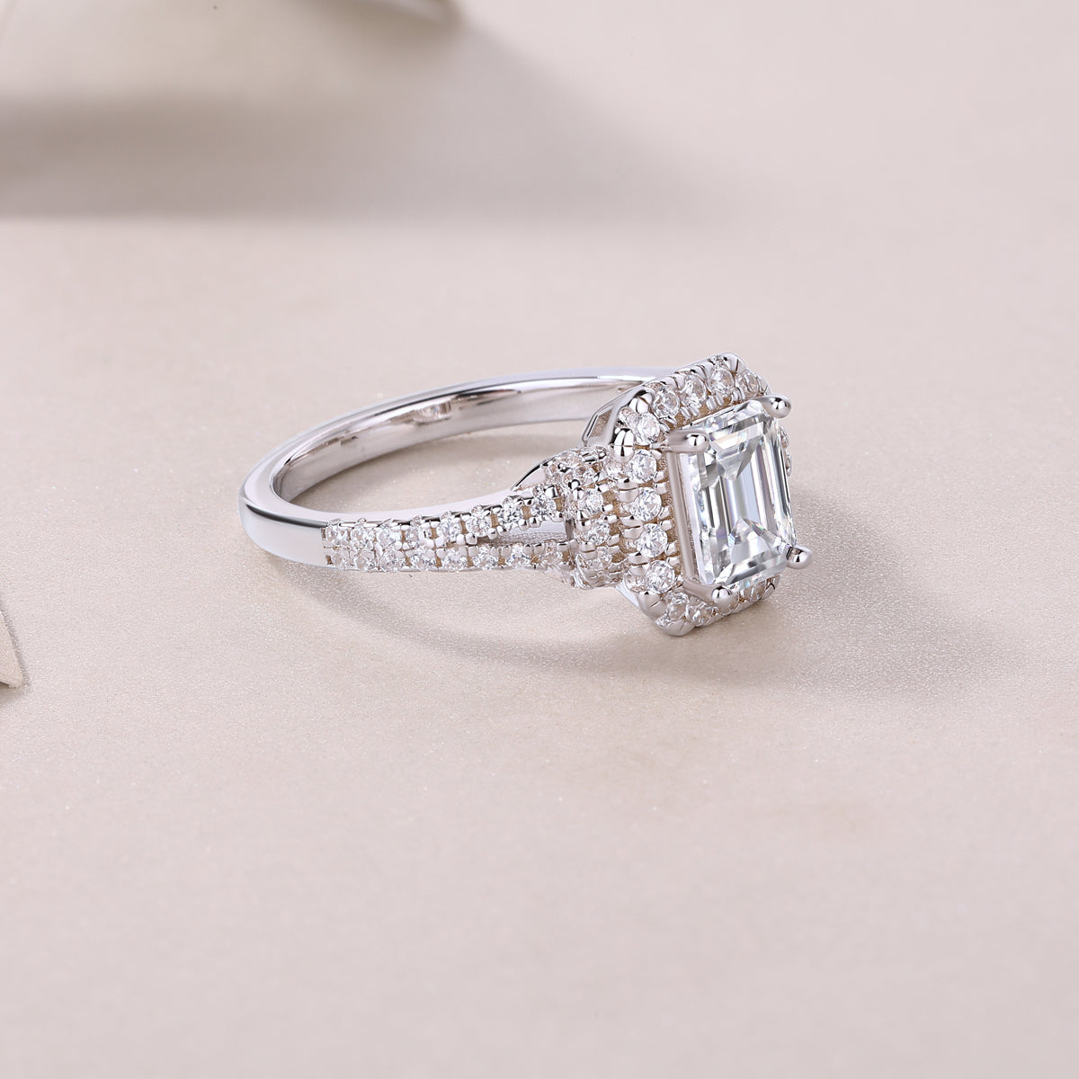Side view of emerald-cut halo moissanite ring with double pavé split shank