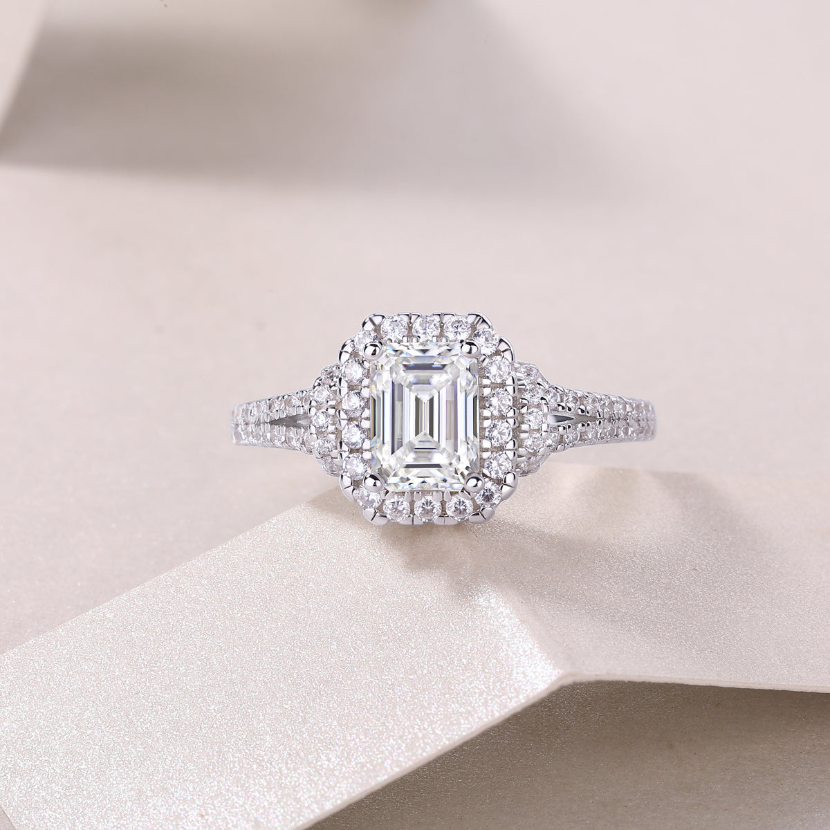 Emerald-cut halo moissanite ring with double pavé split shank and side stones