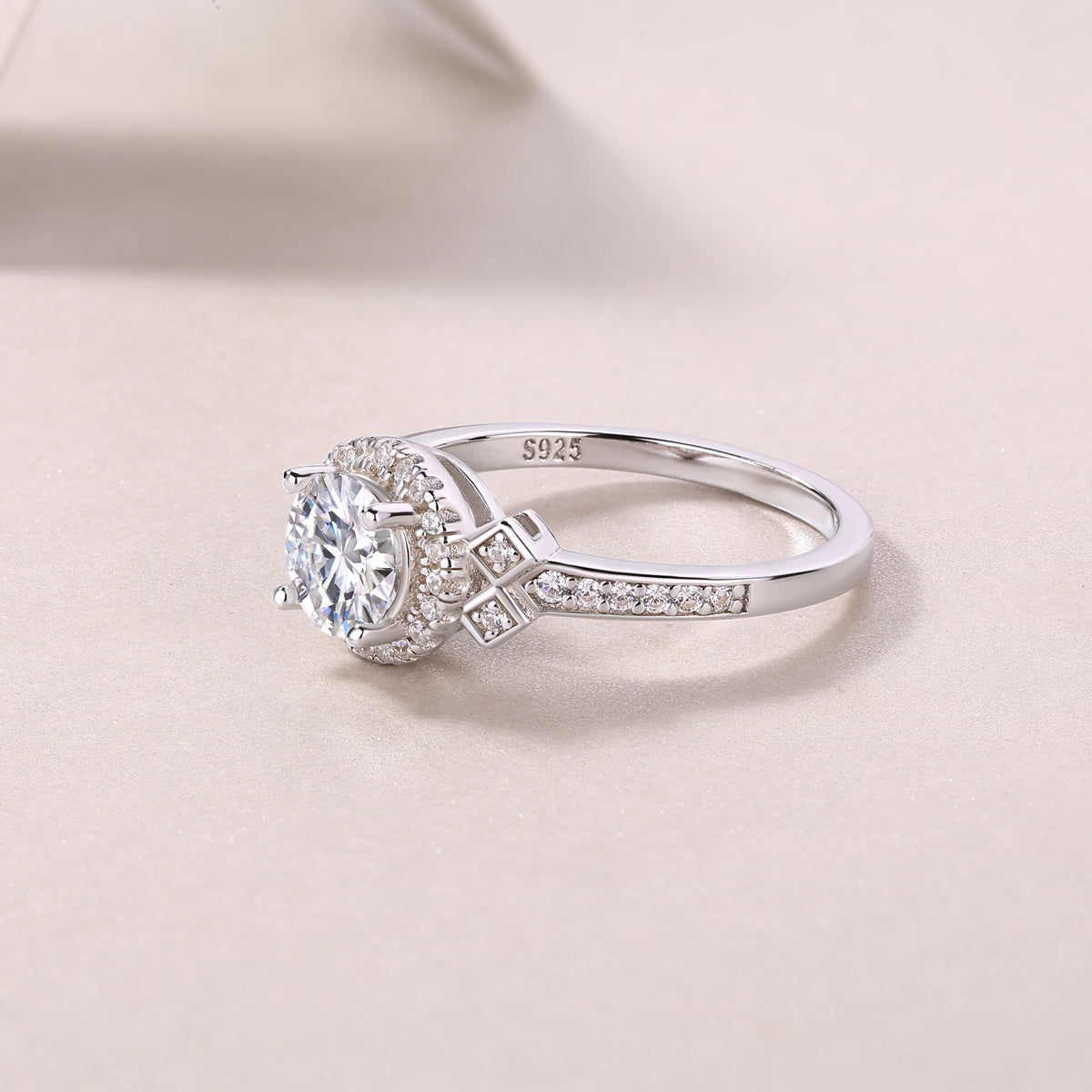 Side view of round halo art deco cross pavé ring with “925” marking on band